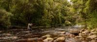 Crossing a river on the South Coast Track in Tasmania | John Dalton