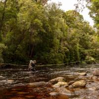 Crossing a river on the South Coast Track in Tasmania | John Dalton