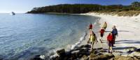 Walkers on 4 Mile Beach on Maria Island