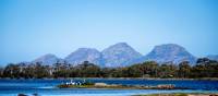 Sheer pink granite mountains overlook the calm, crystal clear water of Oyster Bay | Andrew Wilson