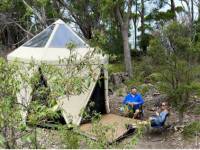 Hikers putting up their feet at our coastal Eco-Comfort Camp |  <i>Michael Buggy</i>