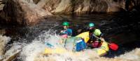 Guides taking the raft through wilder rapids | Glenn Walker