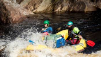 Guides taking the raft through wilder rapids | Glenn Walker