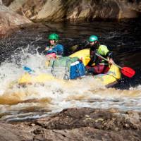 Guides taking the raft through wilder rapids | Glenn Walker