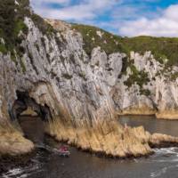 Guests pass through a seacave in tender