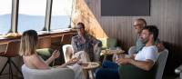 Guests relaxing in expedition vessel Odalisque's Wheelhouse Lounge & Bar