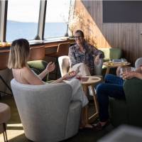 Guests relaxing in expedition vessel Odalisque's Wheelhouse Lounge & Bar