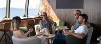 Guests relaxing in expedition vessel Odalisque's Wheelhouse Lounge & Bar