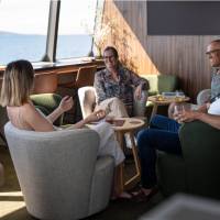 Guests relaxing in expedition vessel Odalisque's Wheelhouse Lounge & Bar