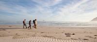 Guests walk along Stephens Bay, a remote beach | Mark Daffey
