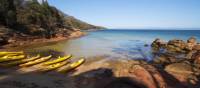 Kayaks resting on a remote Tasmanian beach | Amy Russell