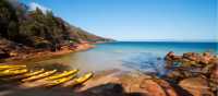 Kayaks resting on a remote Tasmanian beach | Amy Russell