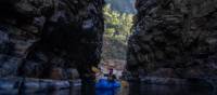 Packrafting through a narrow section of Alum Cliffs Gorge
