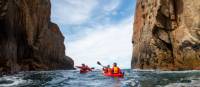 Kayak beneath dramatic scenery along the Tasman Peninsula