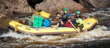 Guides navigating the raft to calmer waters | Glenn Walker