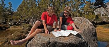 Enjoying the sunshine, reading maps on a Tasmanian Expeditions trek | Don Fuchs
