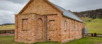 The graveyard near Wybalenna Chapel contains unmarked First Nations peoples graves. Around 300 Aboriginal people were ‘delivered’ there during its time as a mission. | Dietmar Kahles