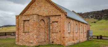 The graveyard near Wybalenna Chapel contains unmarked First Nations peoples graves. Around 300 Aboriginal people were ‘delivered’ there during its time as a mission. | Dietmar Kahles